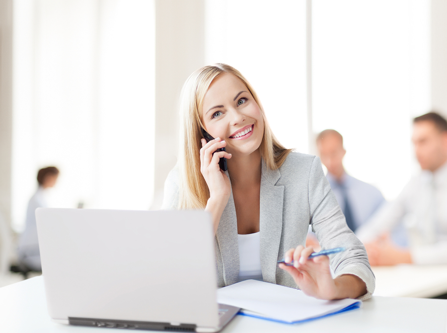 business concept - businesswoman talking on the phone in office