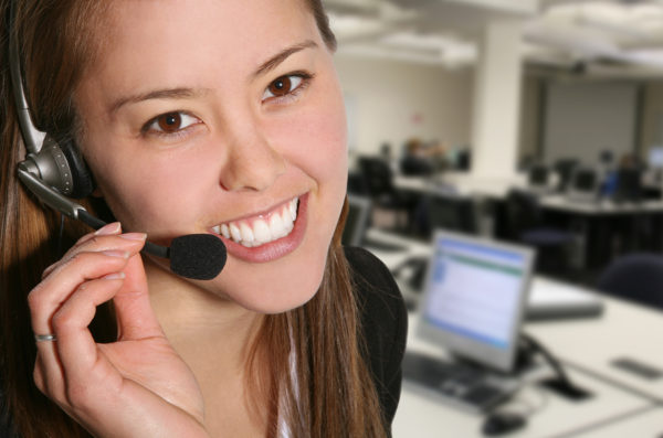 Customer Service Woman A pretty customer service woman taking sales over the phone
