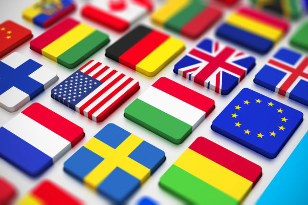 Flags Keyboard Creative abstract business international communication and cartography technology corporate office concept: close macro view of computer PC keyboard from colorful world countries flags with selective focus effect